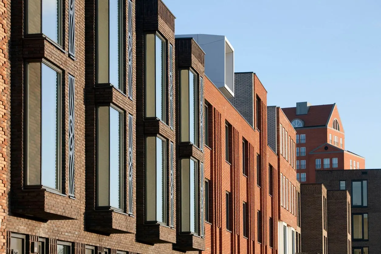 Modern brick buildings under clear blue sky.