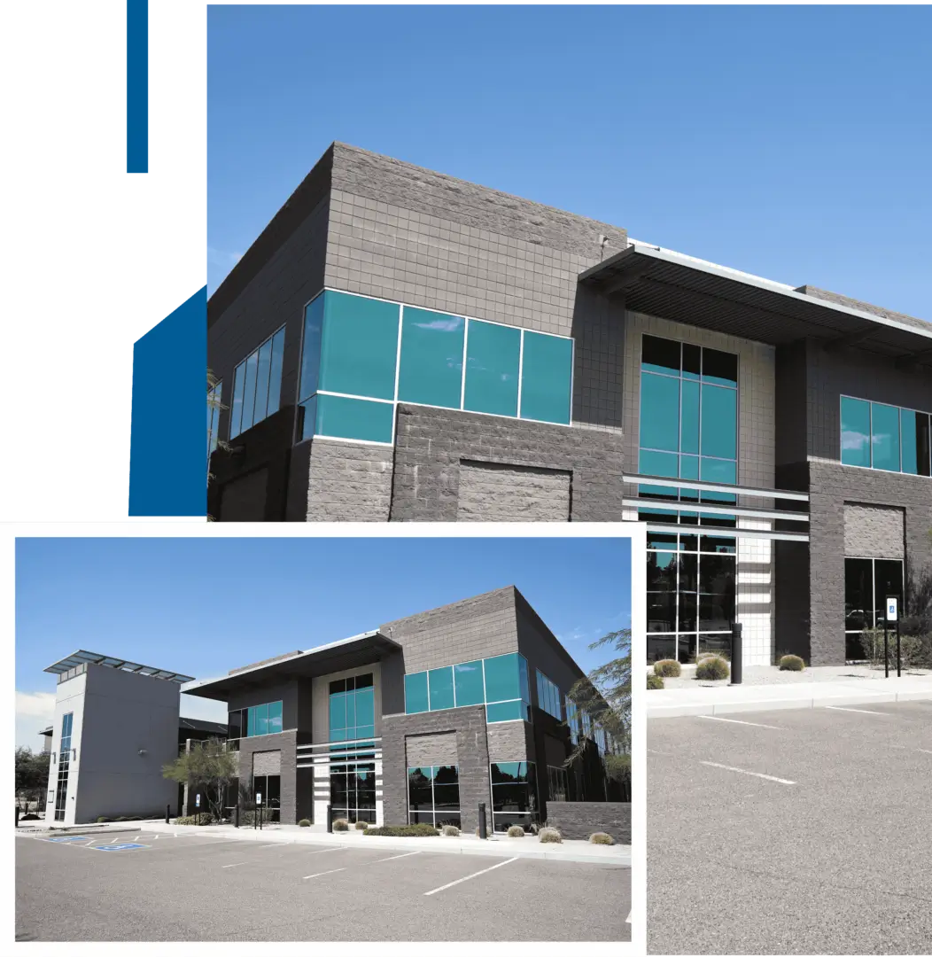 Modern commercial building with blue-tinted windows under a clear sky.