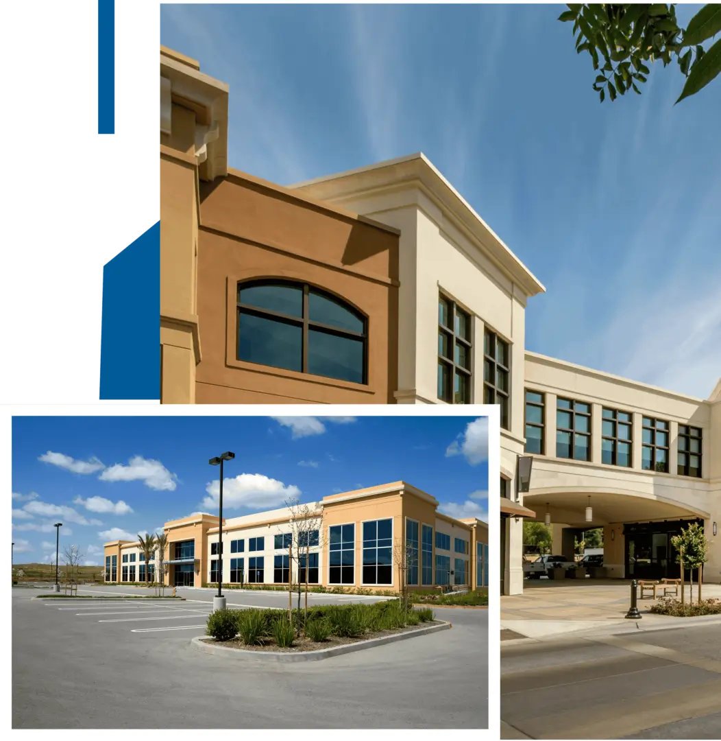 Modern commercial buildings with large windows and clear skies.